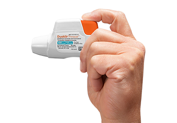Using DUAKLIR<sup>®</sup> PRESSAIR<sup>®</sup> Step 1 PRESSAIR In Hand, Finger Pressing Down on Orange Button